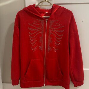 Red zip-up hoodie with rhinestone skeleton design